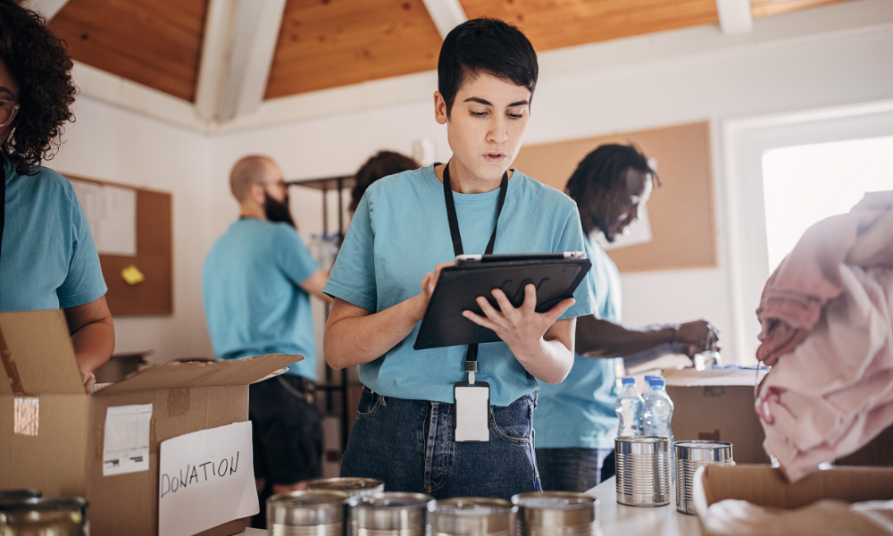 Worker on a tablet at a donation center.